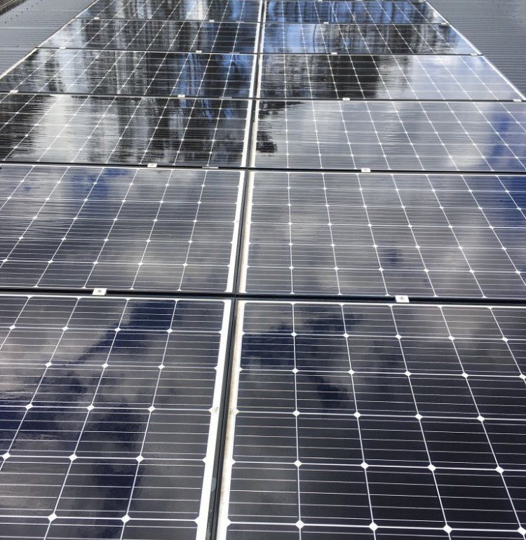Solar Panels On A Red Tiled Roof — Gutter Cleaning In Shoalhaven, NSW