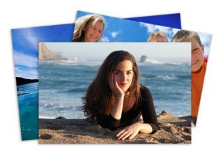 photo of a woman is laying on the beach with her hand on her chin .