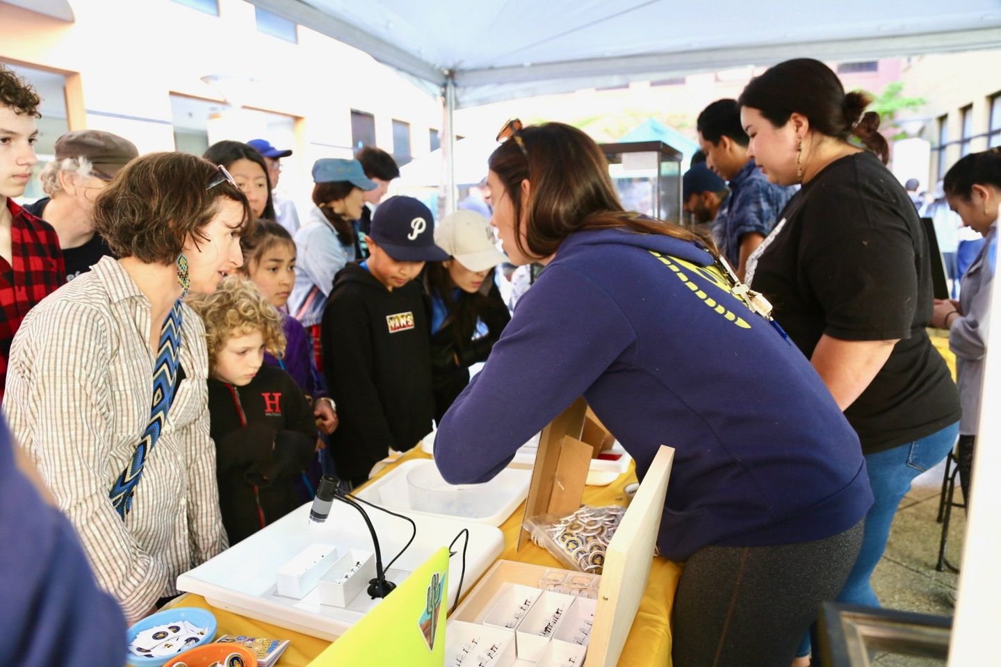 Photo of Tsutsui Lab members presenting about research at a Cal Day open house event.
