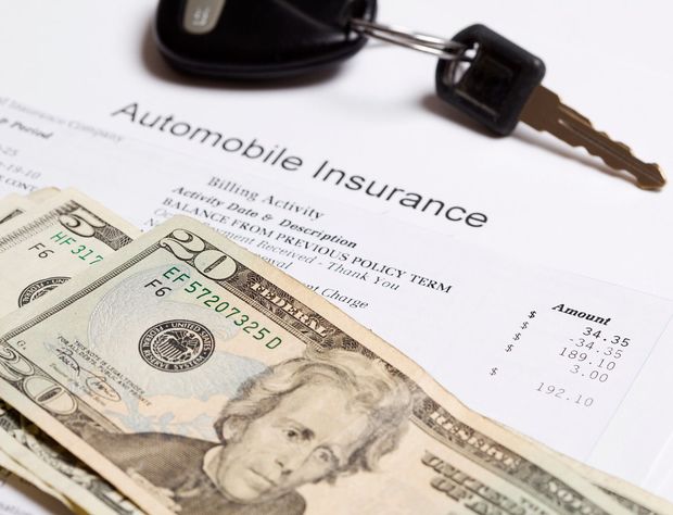 Auto insurance form with car keys and cash on a white background