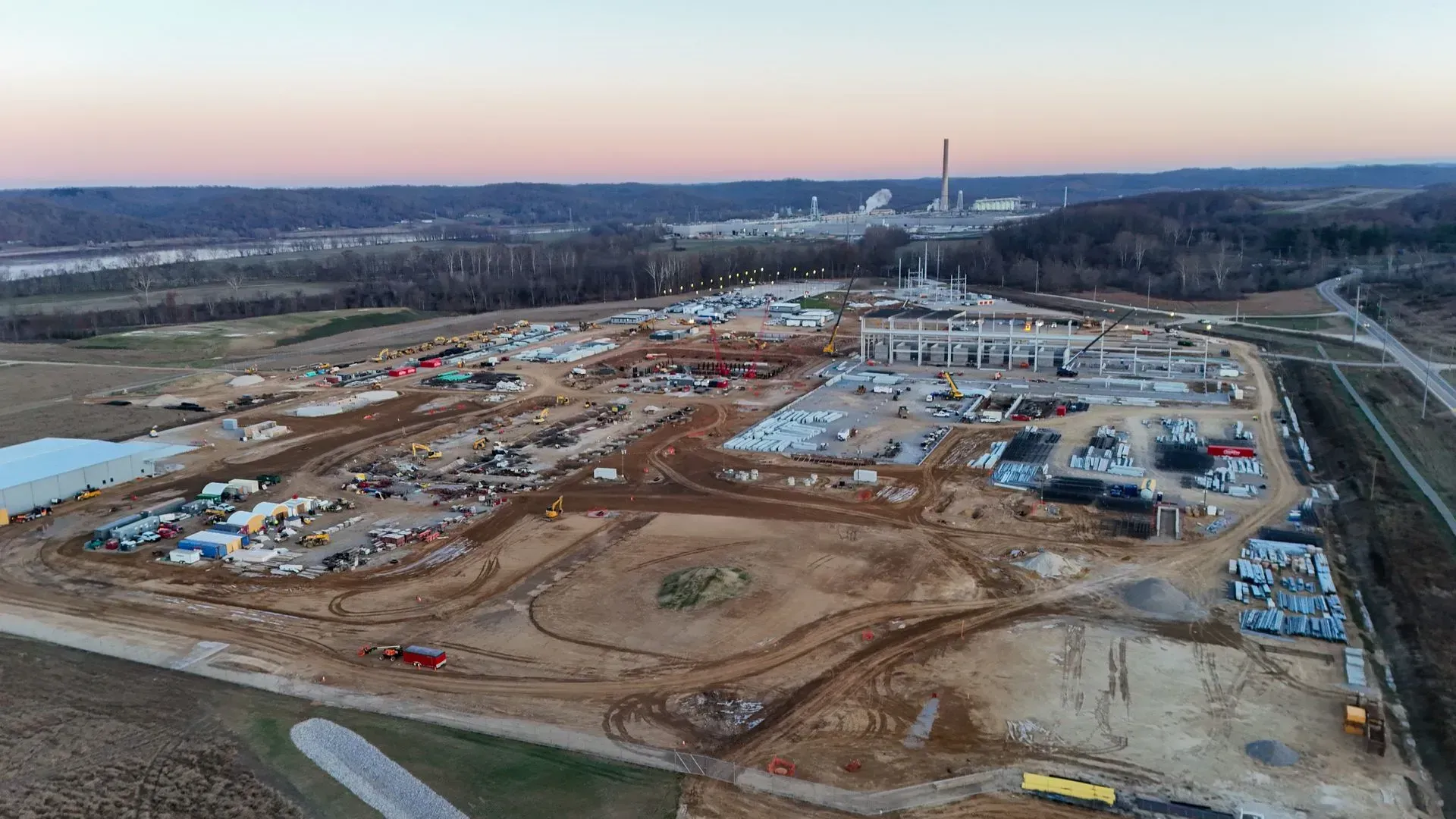 An aerial view of a large construction site in the middle of a field.