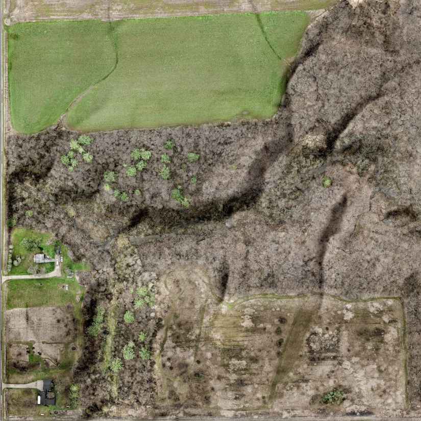 An aerial view of a cell phone tower in the middle of a field.