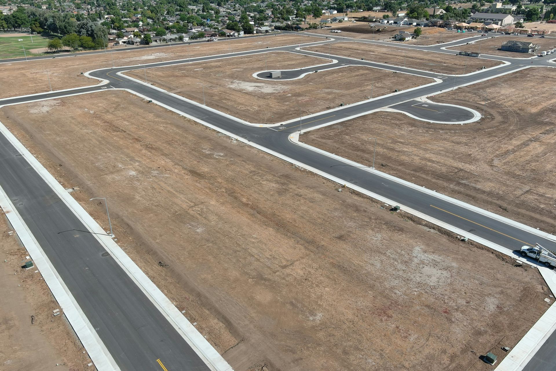 An aerial view of a residential area with a large building in the middle
