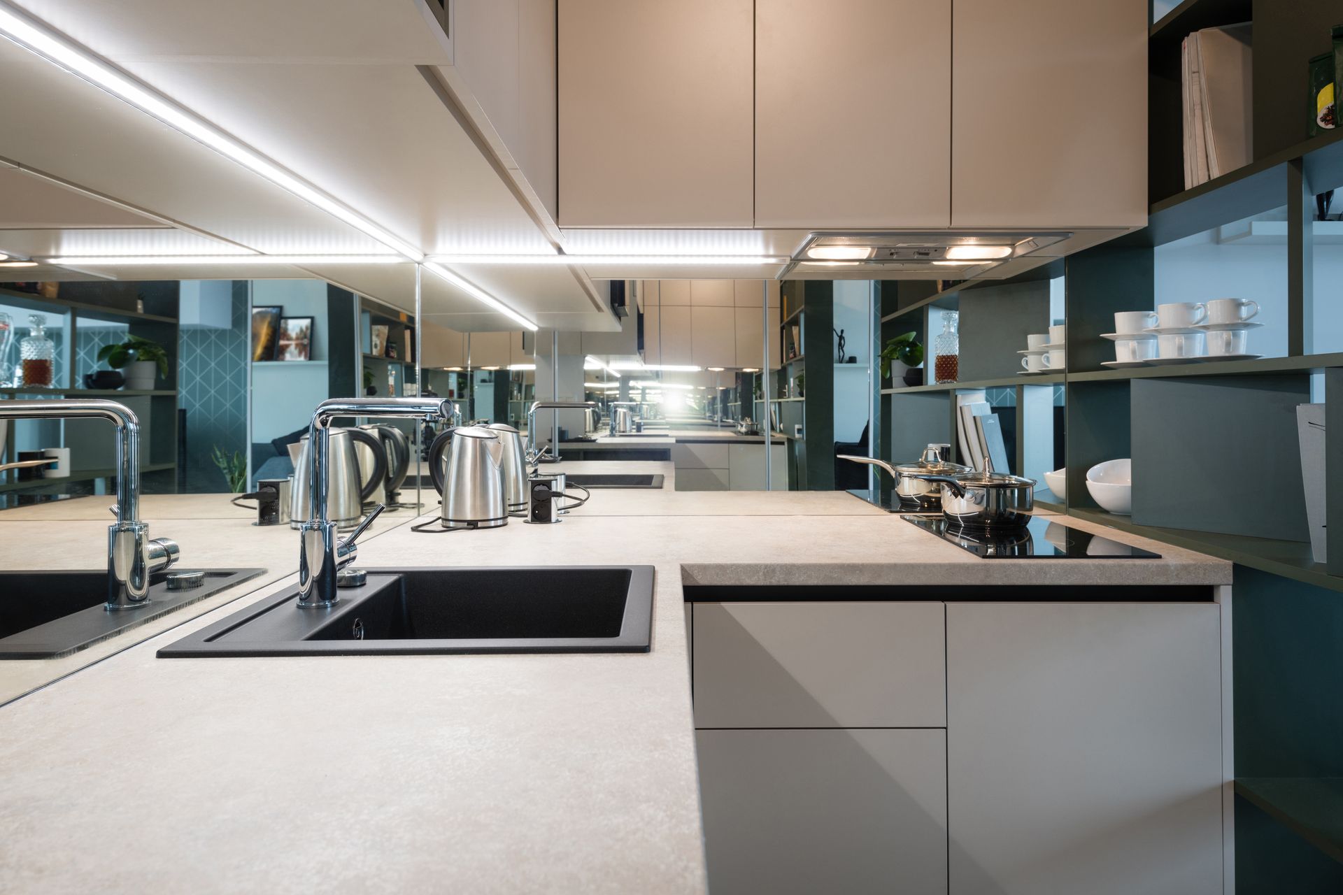 A kitchen with two sinks and a stove top oven.