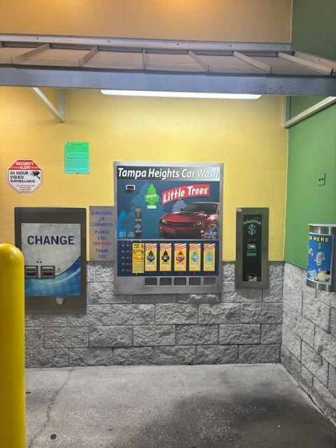 A car being washed at a car wash, water spraying, close-up of tires and undercarriage. A car being washed at a car wash, water spraying, close-up of tires and undercarriage.