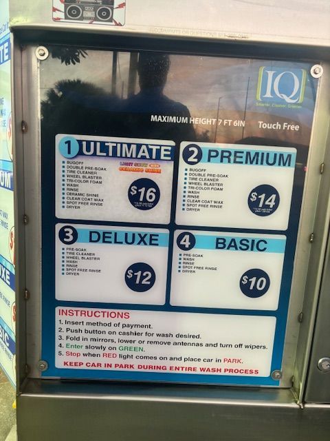 Car wash menu with four wash packages. Costs range from $10 to $16. Instructions at the bottom.