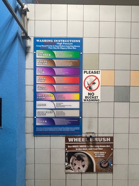 Sign at car wash with washing instructions and wheel brush details. 