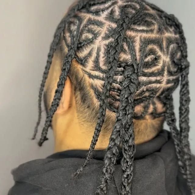 Back of head with intricate braided cornrows and loose braids against a neutral background