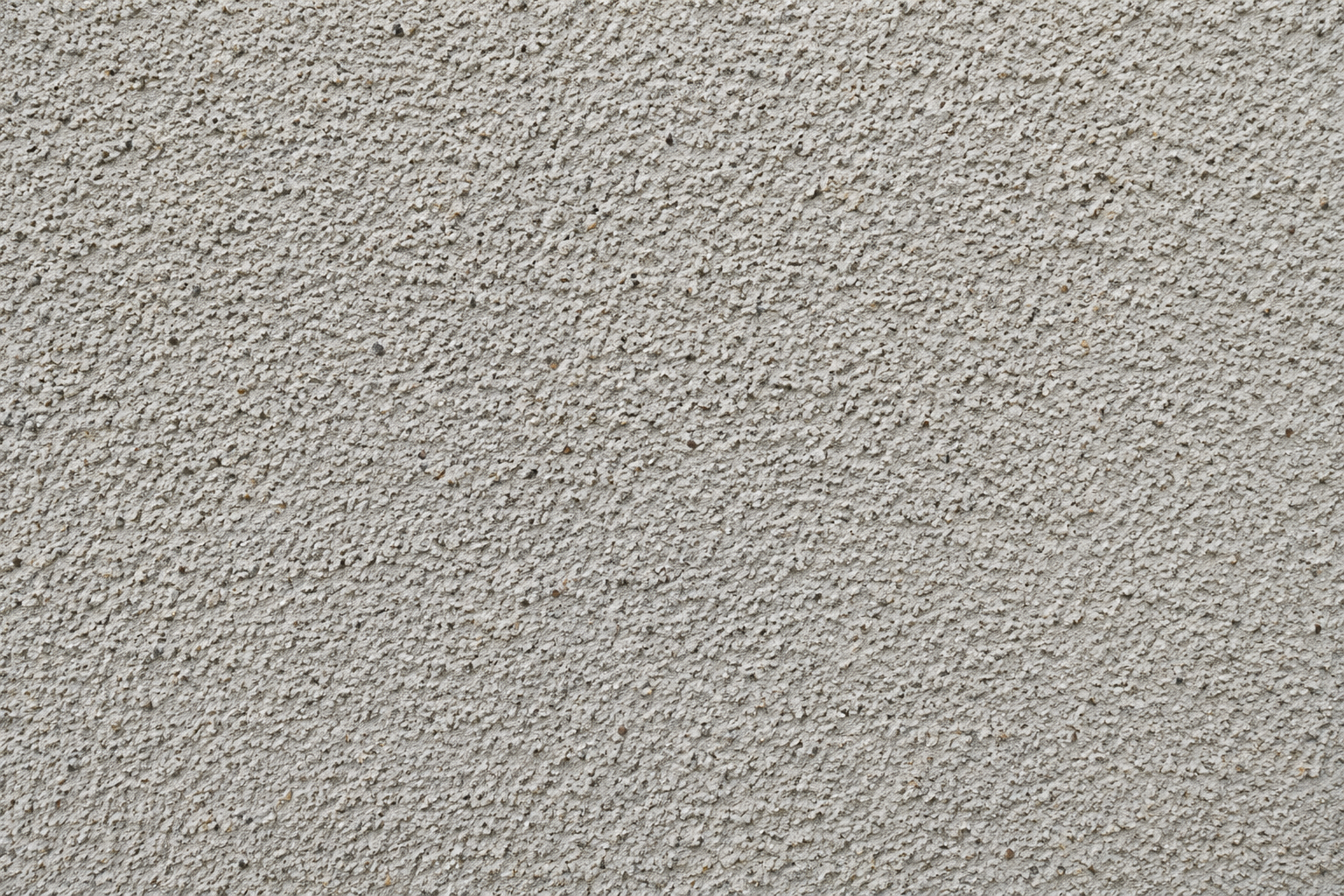 Close-up of a light gray textured surface with a rough, speckled pattern