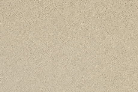 Beige textured wall or ceiling surface with speckled finish