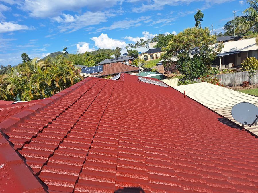 A Red Tiled Roof of a House With a Satellite Dish on It — Roofing Gold Coast in Tallebudgera, QLD