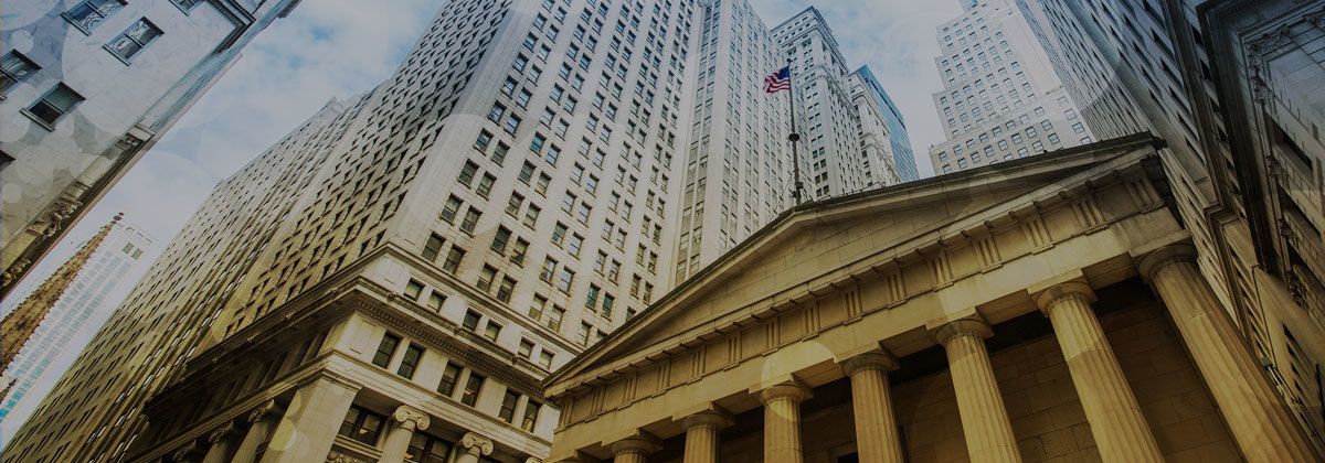 Skyscrapers and a neoclassical building shot from below against a cloudy sky