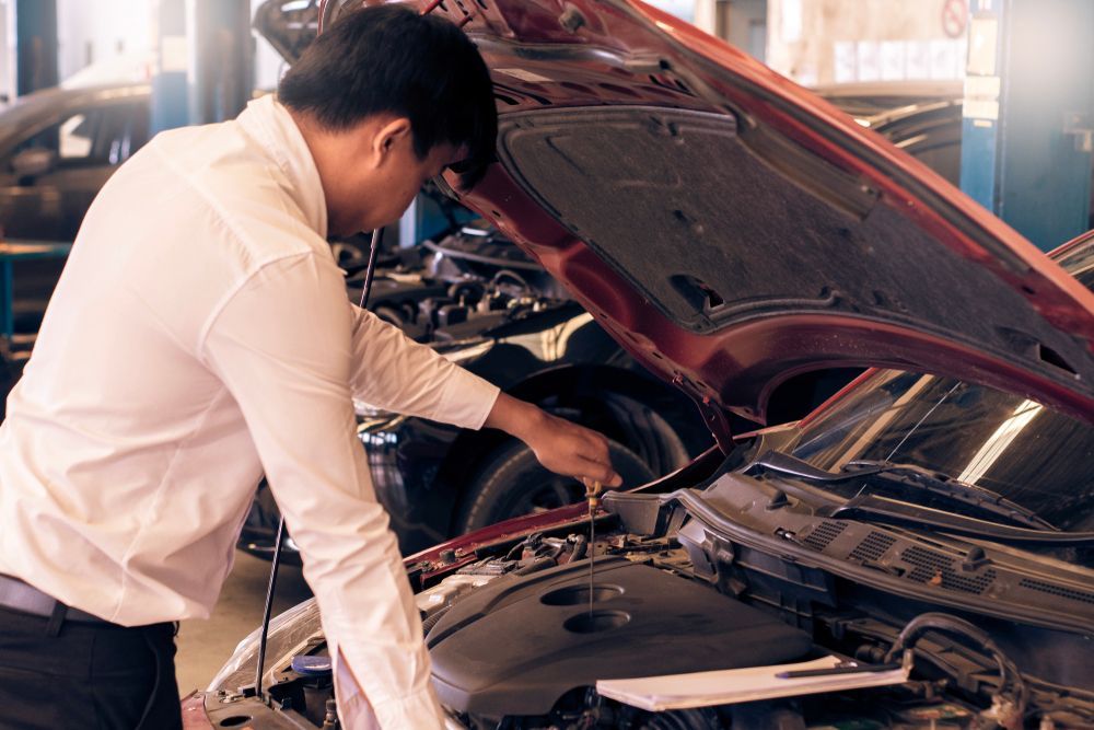 Mechanic in Shirt Examines Car Engine in a Repair Shop — COD Automotive in Ashmont, NSW