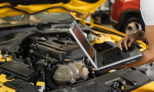 A Mechanic Servicing a Yellow Car — COD Automotive in Ashmont, NSW