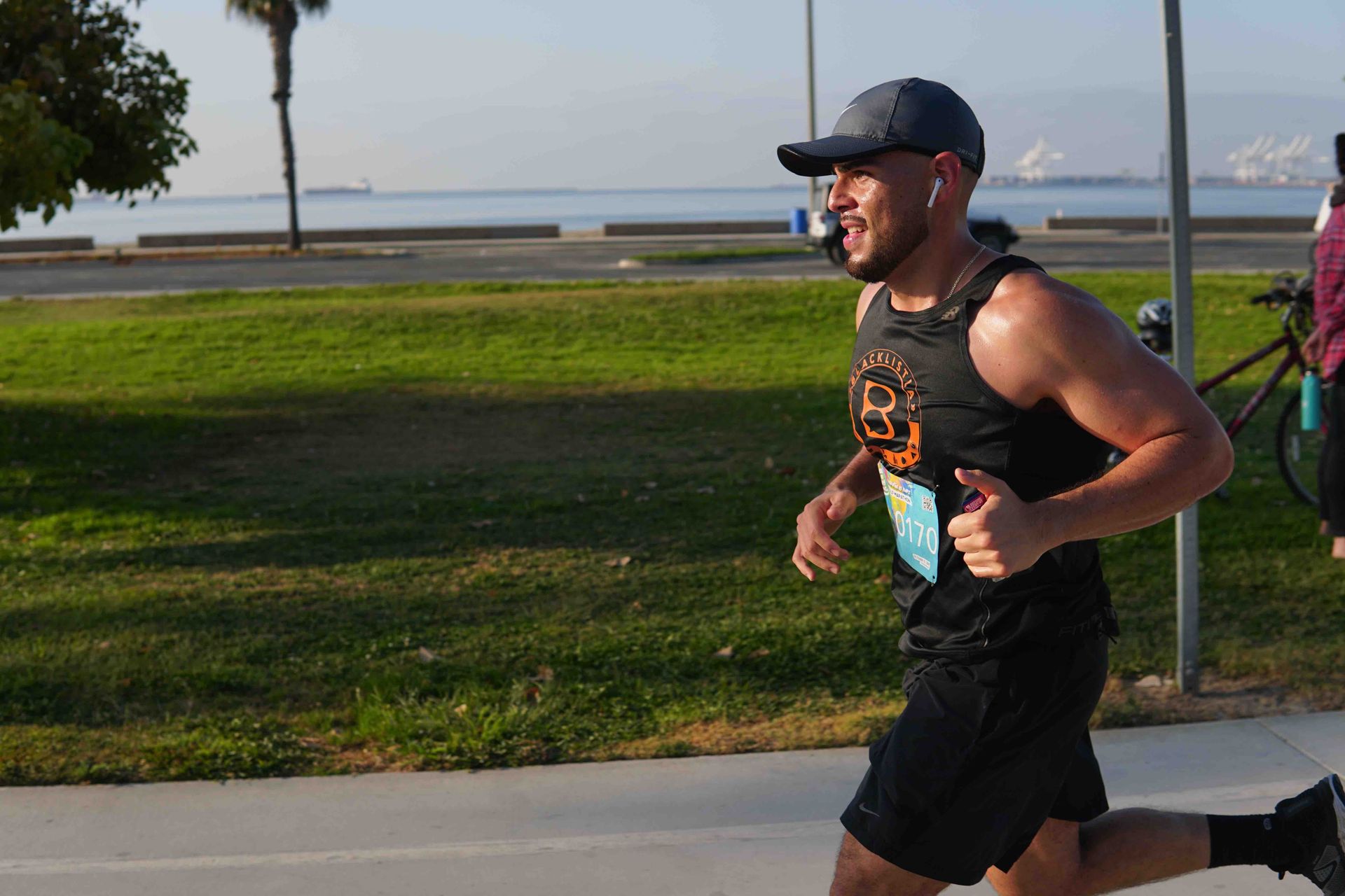 A man is running a marathon in a park.