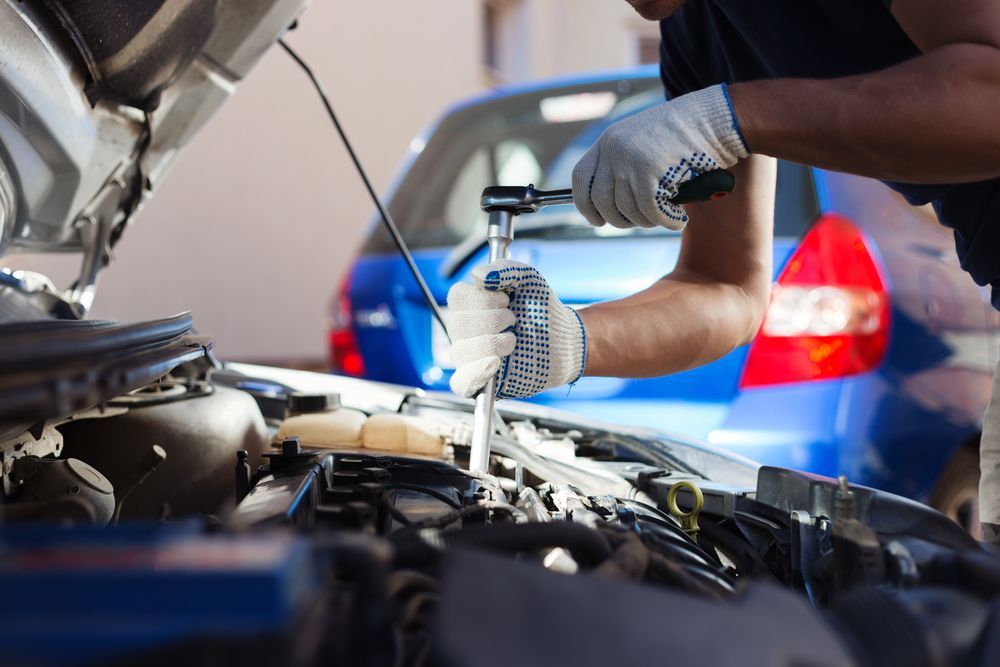 A Man is Working on the Engine of a Car With the Hood Open — South Coast Radiators In Port Macquarie, NSW
