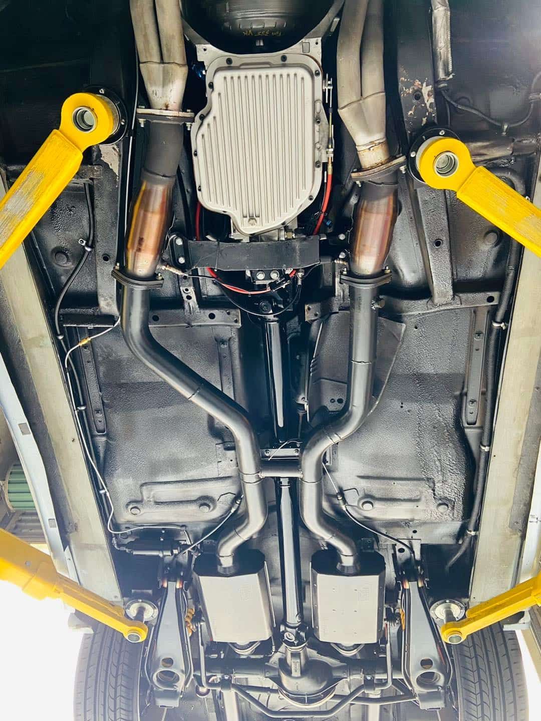 A Close Up of the Underside of a Car on a Lift — South Coast Radiators In Sutherland, NSW