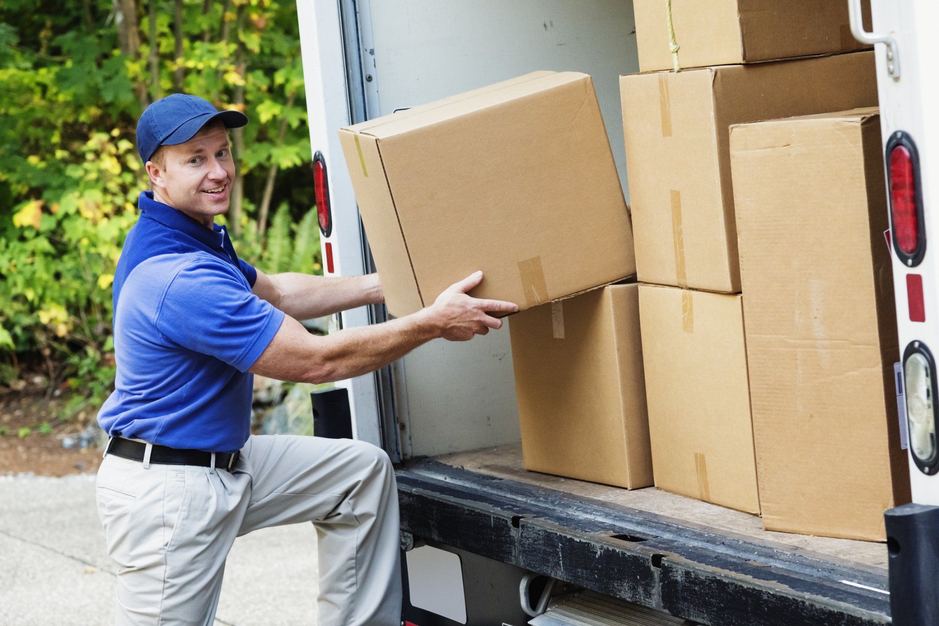Men Carrying Box — Colorado Springs, CO — Helping Hands Moving Men Carrying Box — Colorado Springs, CO — Helping Hands Moving