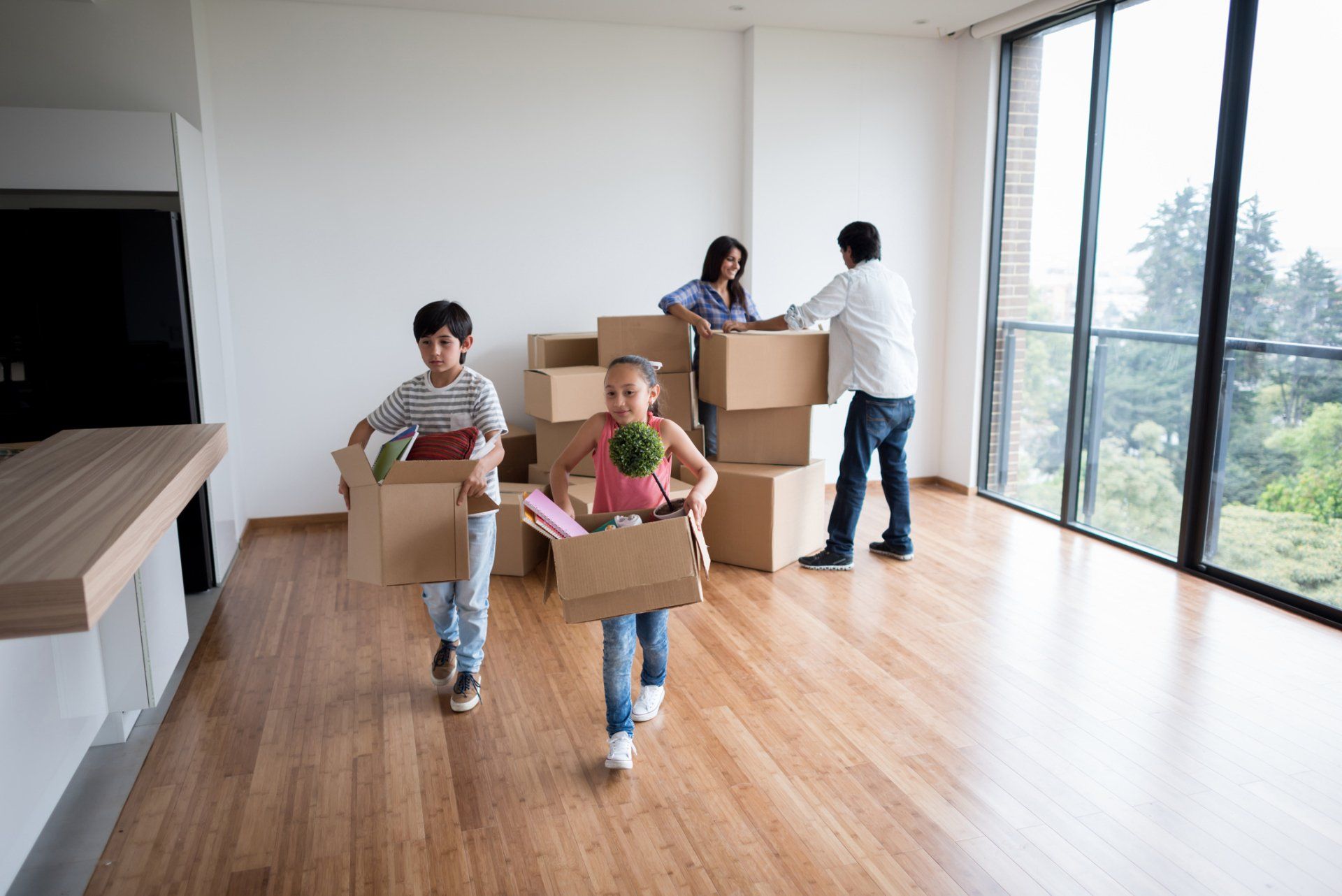 Family With Boxes — Colorado Springs, CO — Helping Hands Moving