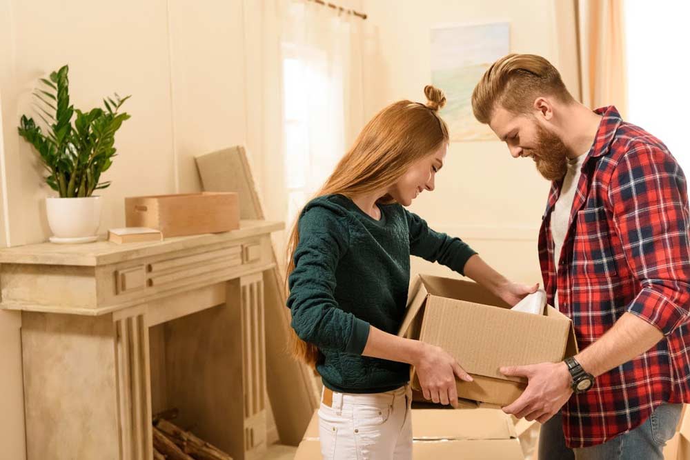 Couple Holding Box — Colorado Springs, CO — Helping Hands Moving