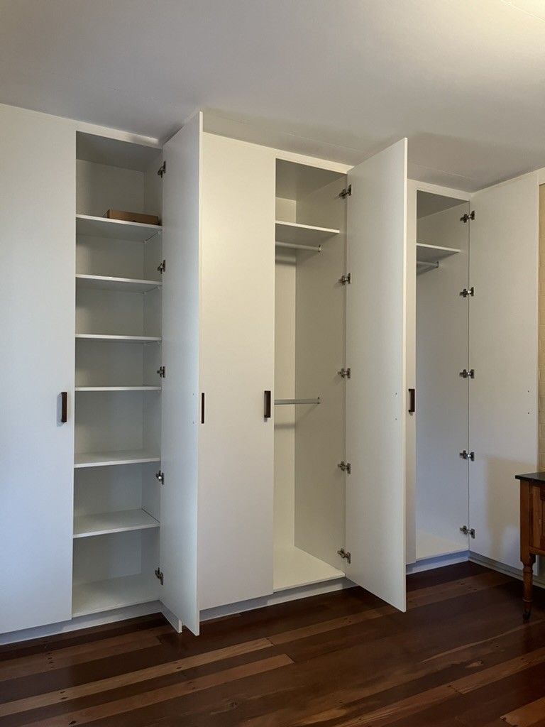 Room With a Wooden Floor and White Cabinets With the Doors Open — D Hinged Kitchens & Joinery in Main Arm, NSW