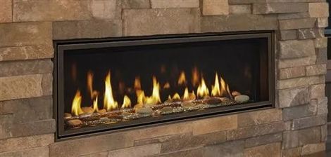 a fireplace is built into a stone wall in a living room
