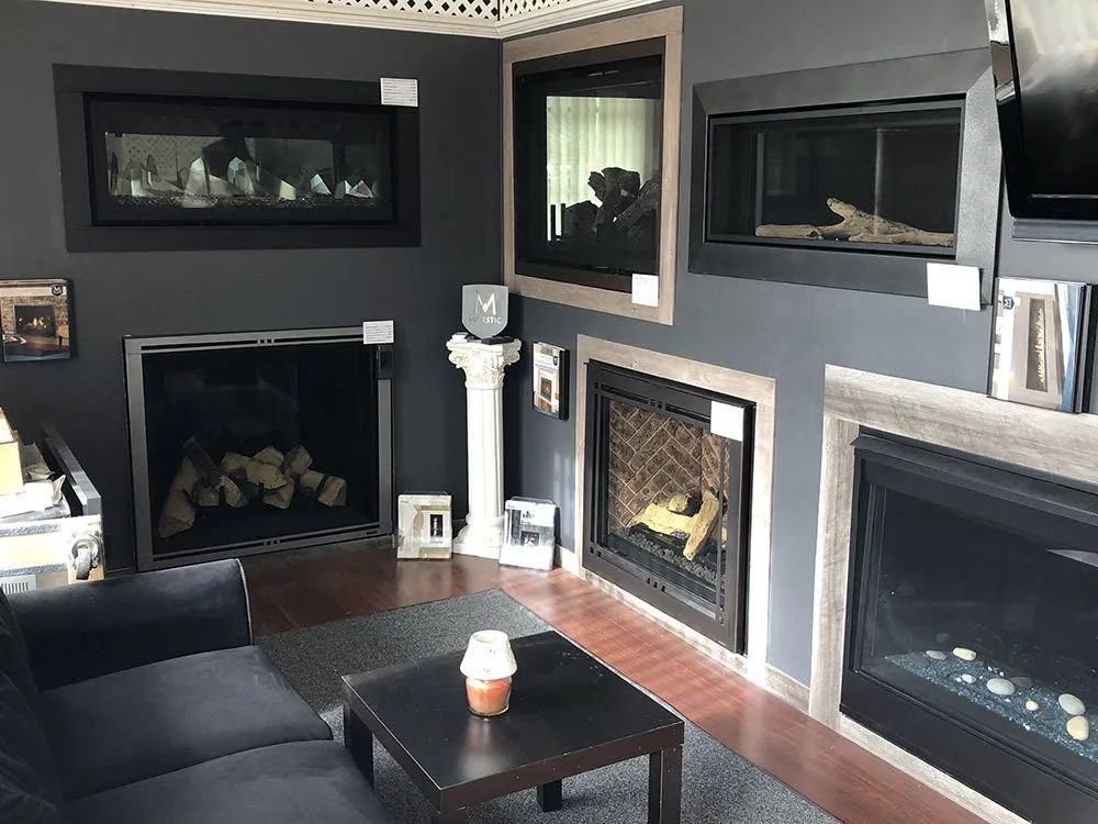 A living room with a couch , table and fireplace.