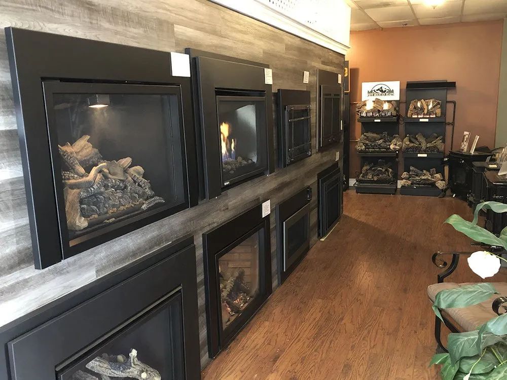 A showroom filled with a variety of fireplace inserts.