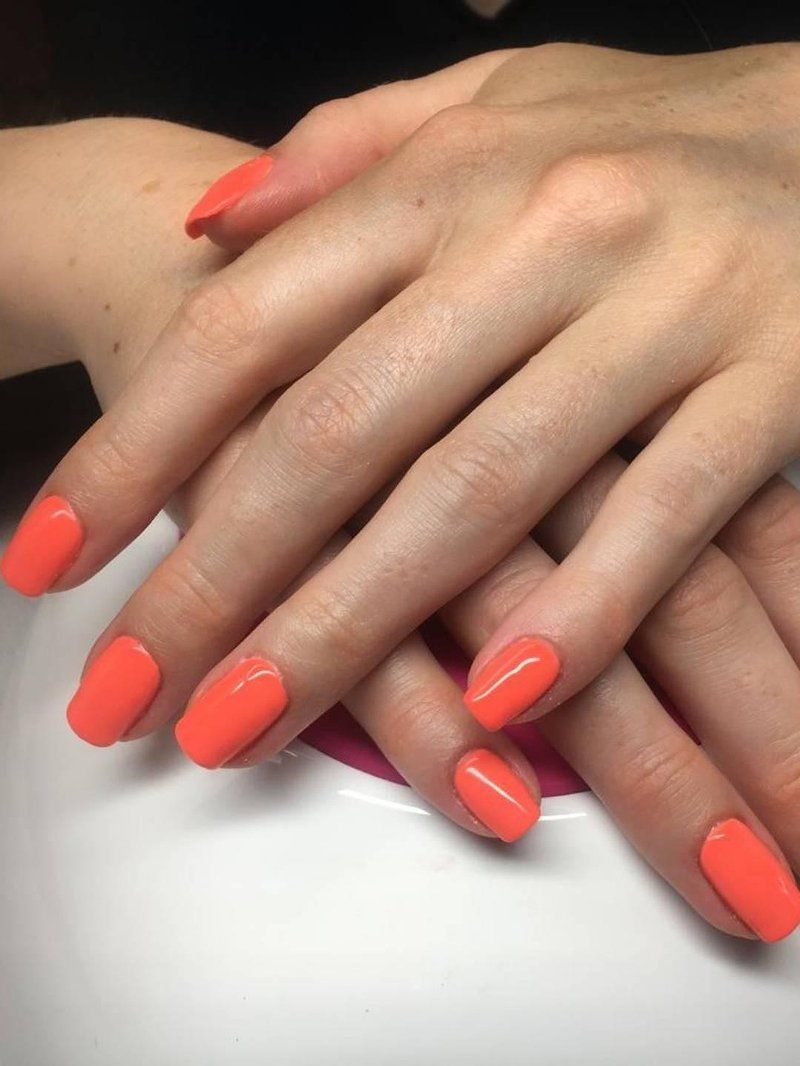 Gel manicure with bright orange chip-resistant polish at Perfect You Spa
