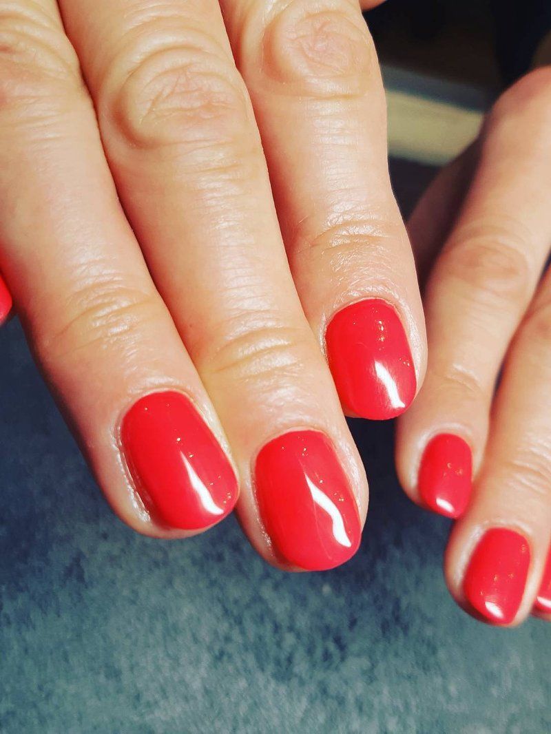 Luxury manicure result with glossy red polish at Perfect You Spa