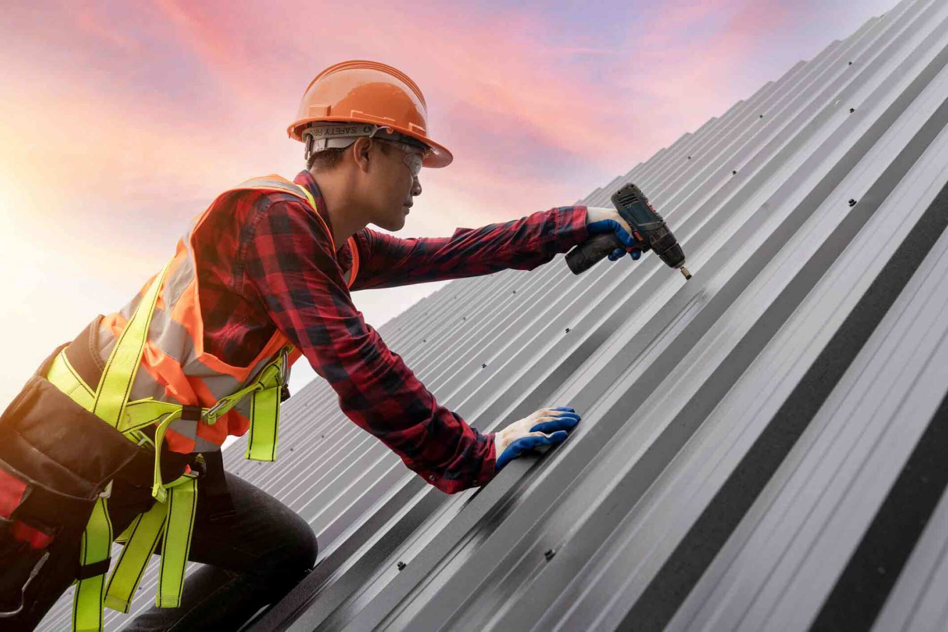 Worker Drilling Roof — Lakeville, MN — Bradach Roofing Siding & Window