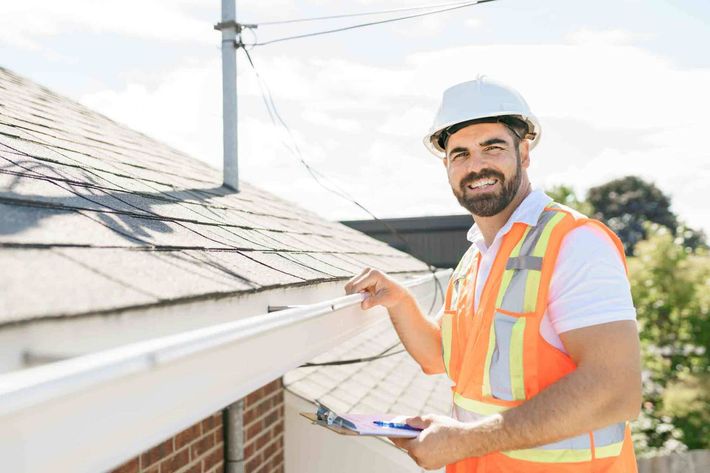 Worker Smiling Beside The Roof — Lakeville, MN — Bradach Roofing Siding & Window