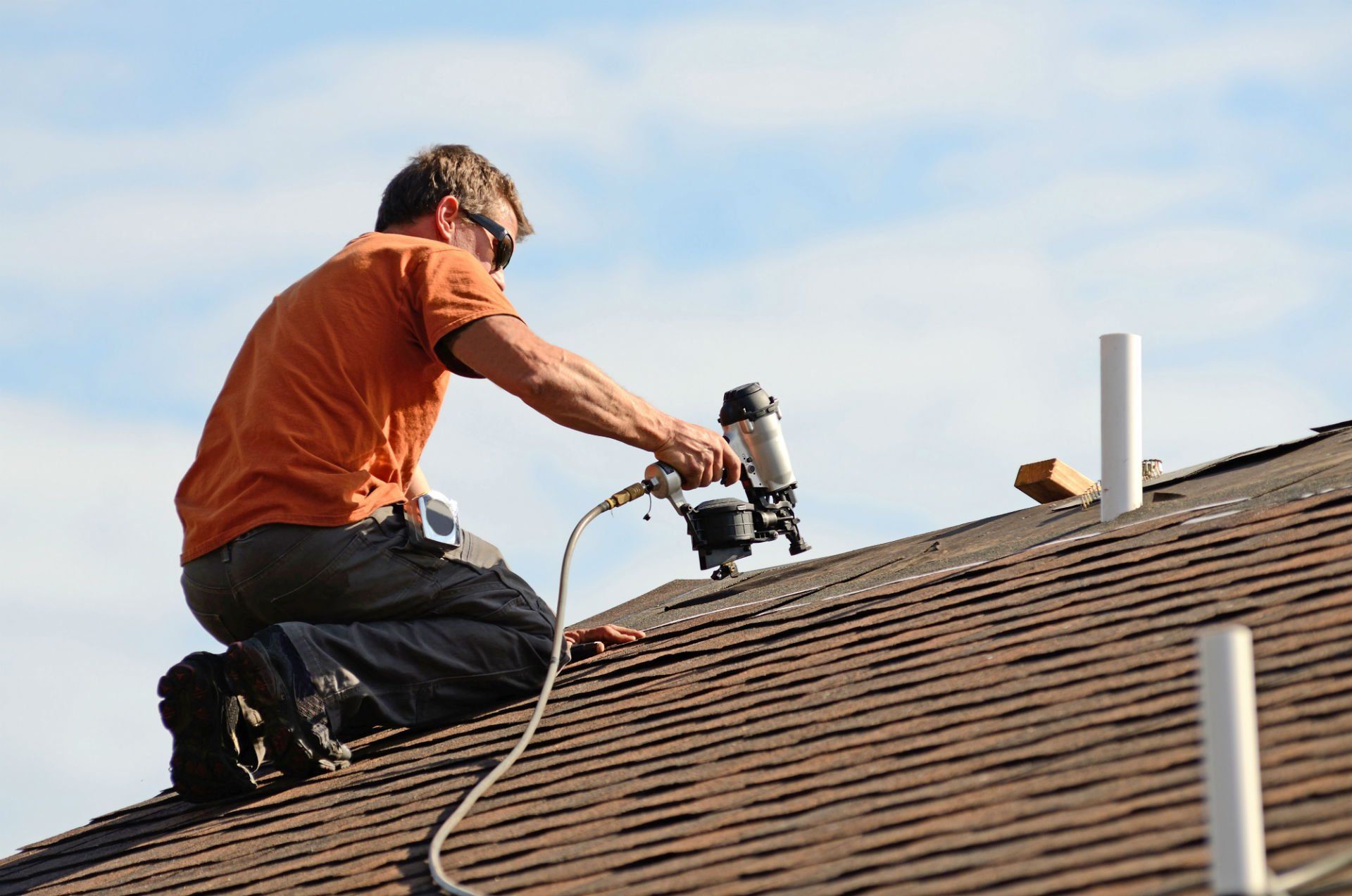 Man Fixing Roof — Lakeville, MN — Bradach Roofing Siding & Window Man Fixing Roof — Lakeville, MN — Bradach Roofing Siding & Window