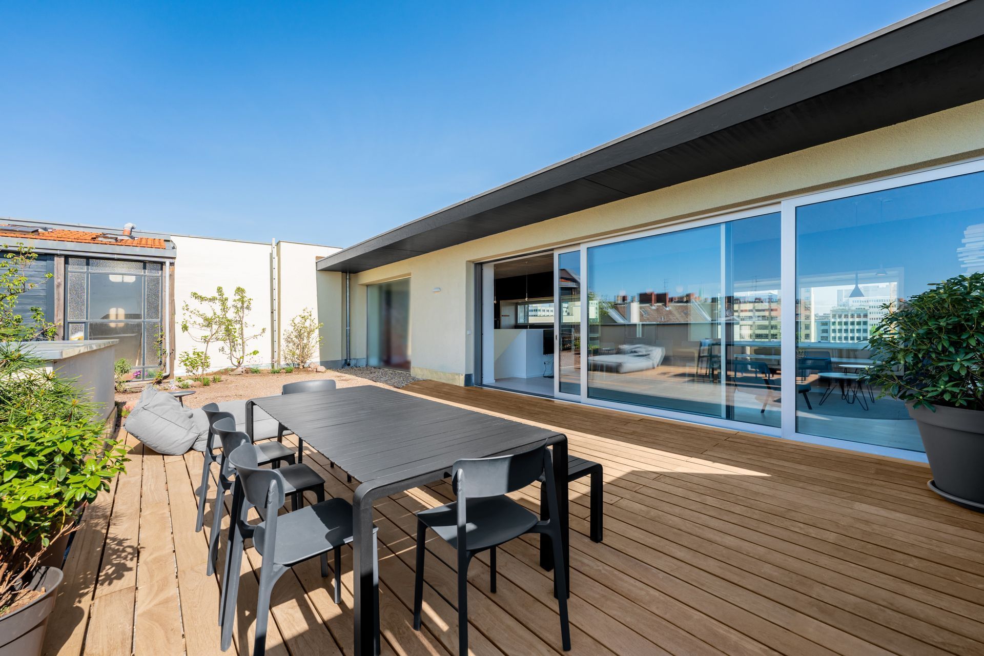 A large deck with a table and chairs on it