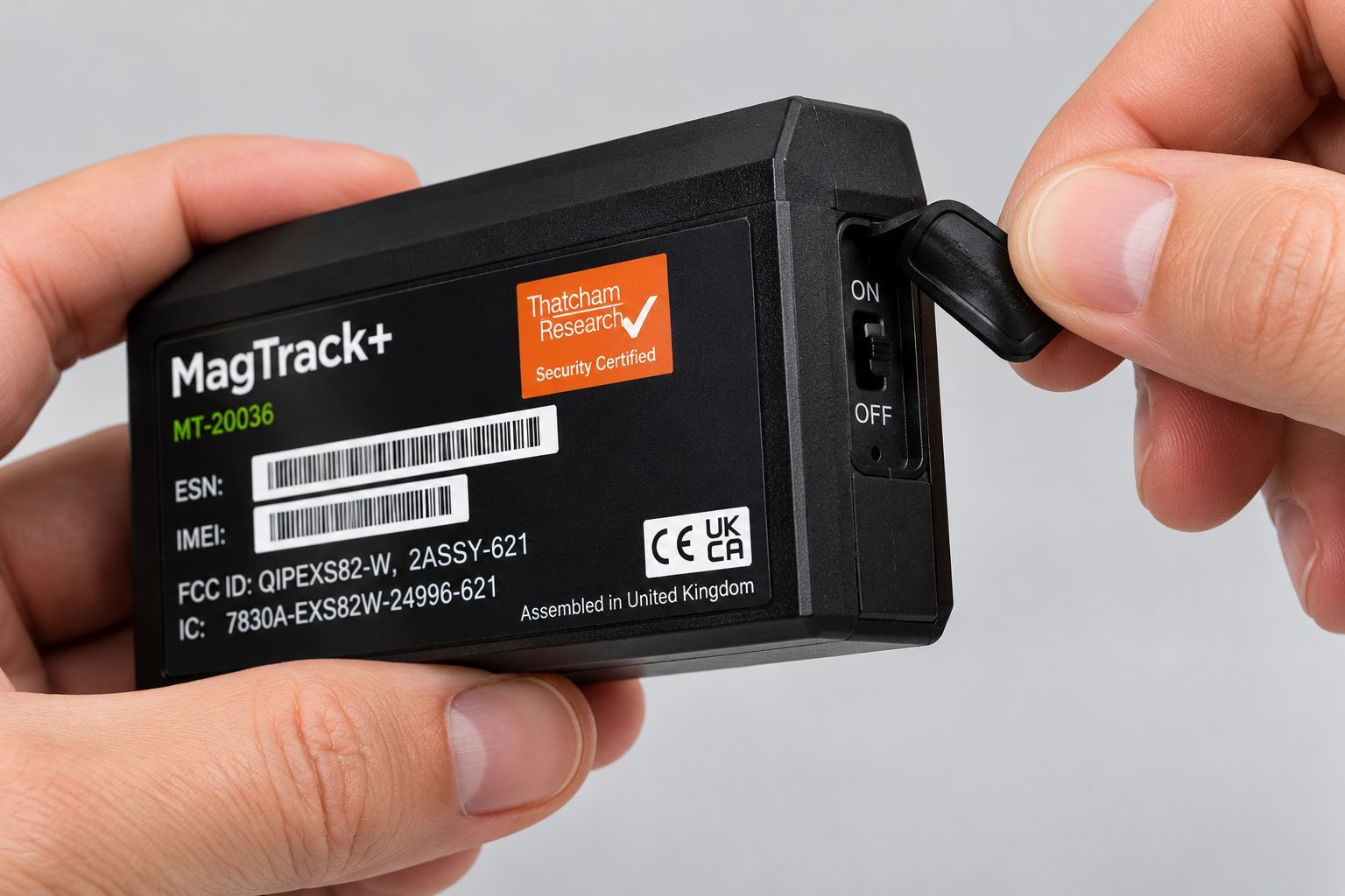 AGL MagTrack+ tracker being switched on before installation by opening the rubber side cover.