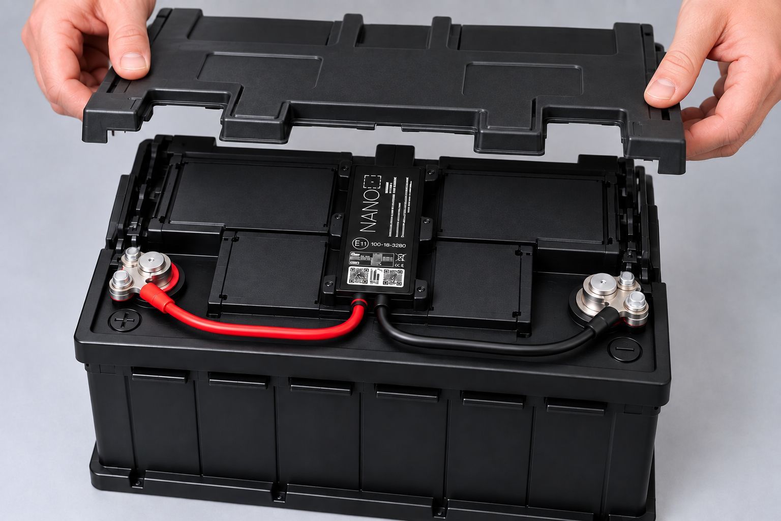Battery cover being replaced after an AGL Nano tracker is securely installed and connected to the vehicle battery.