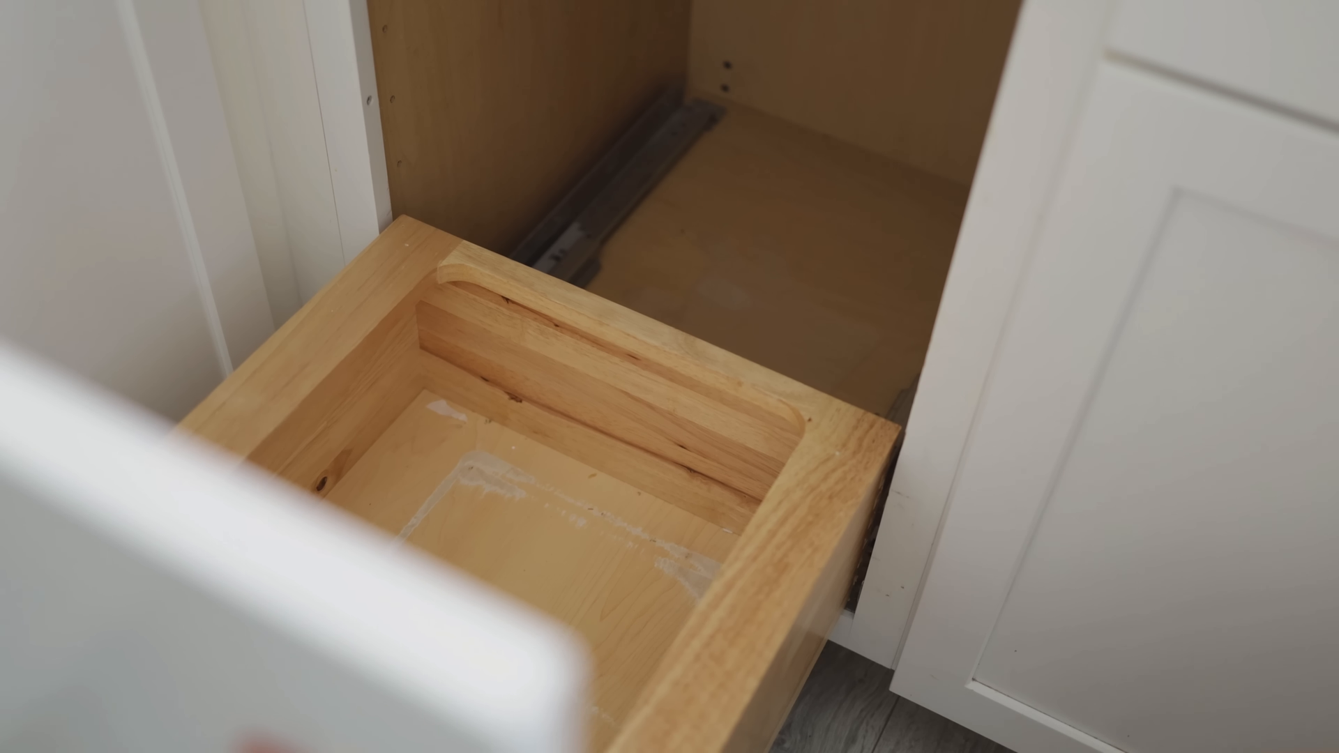Apartment cleaning service tidying a compact Alphabet City kitchen