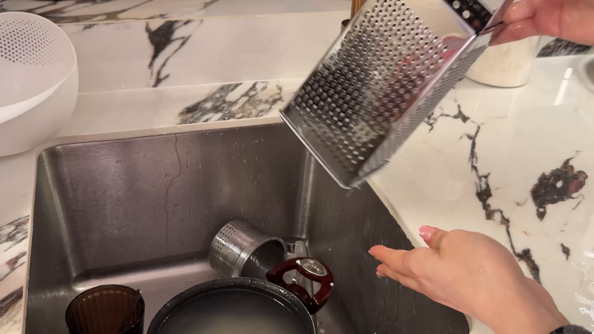 Housekeeper cleaning bathroom fixtures in a Sutton Place Manhattan apartment