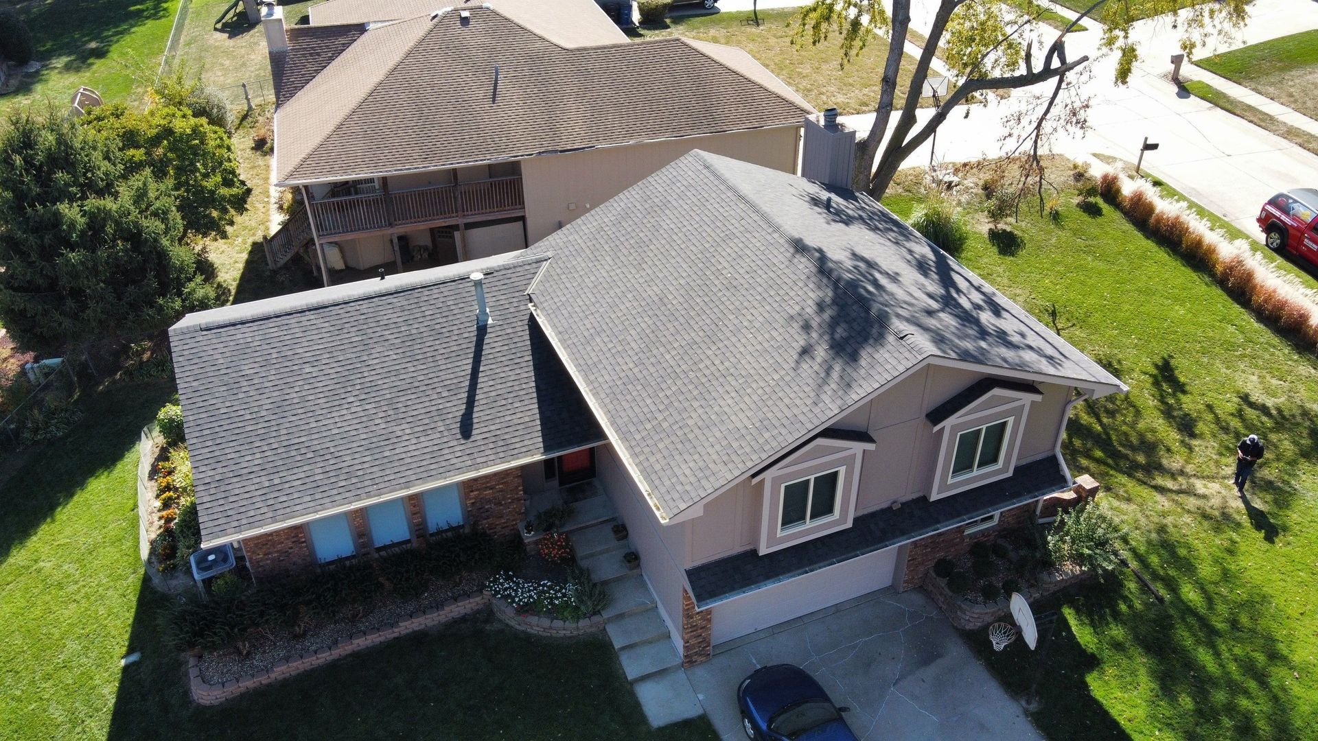 An aerial view of a house with a car parked in front of it.