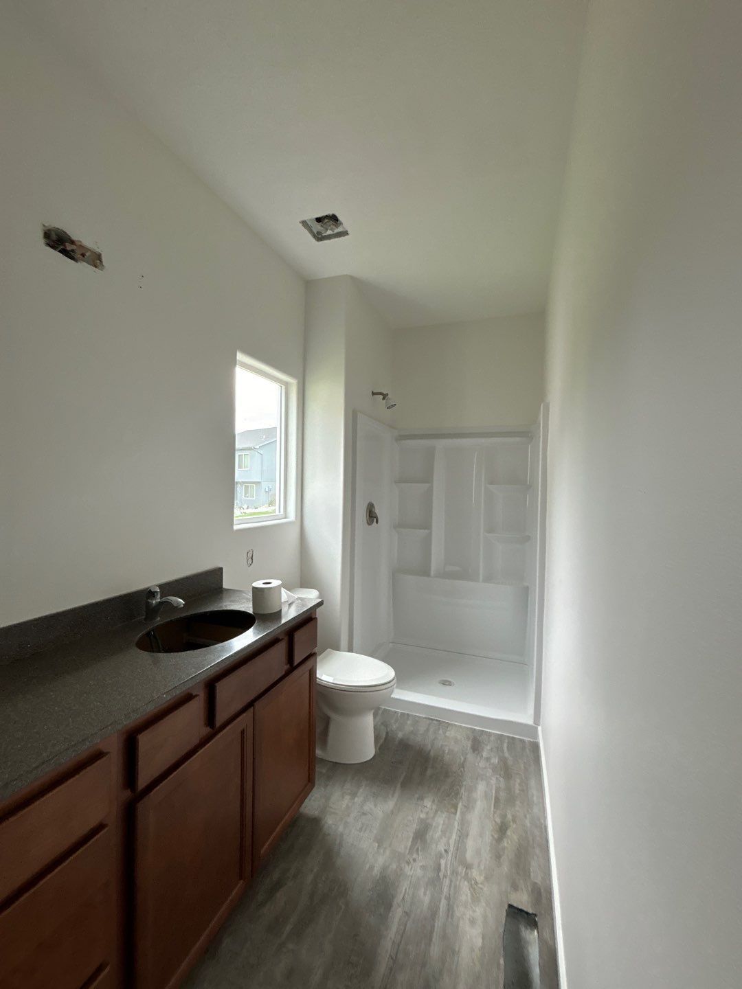 A bathroom with a sink, toilet and shower.