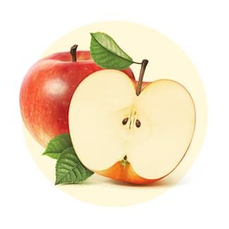 A whole red apple and a halved red apple with green leaves, set against a circular, pale yellow background.