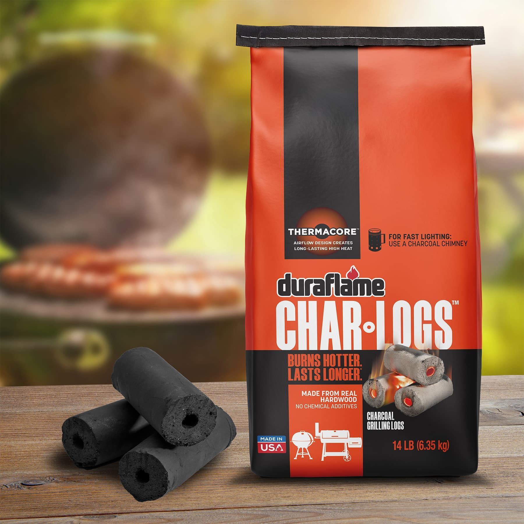 duraflame Char-Logs real wood charcoal with grill blurred in background. Charcoal grilling logs, stacked next to bag. High heat charcoal logs, High quality charcoal for grilling.