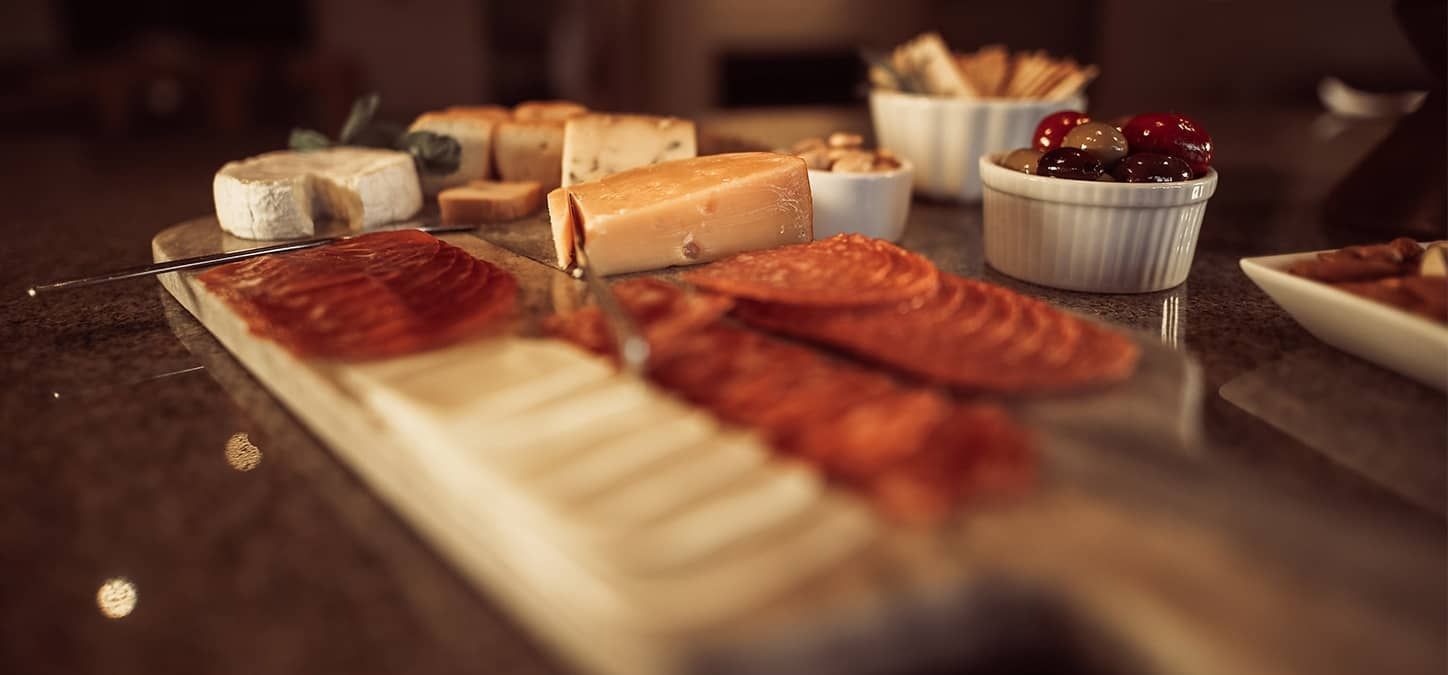 A table topped with a variety of cheeses and meats.
