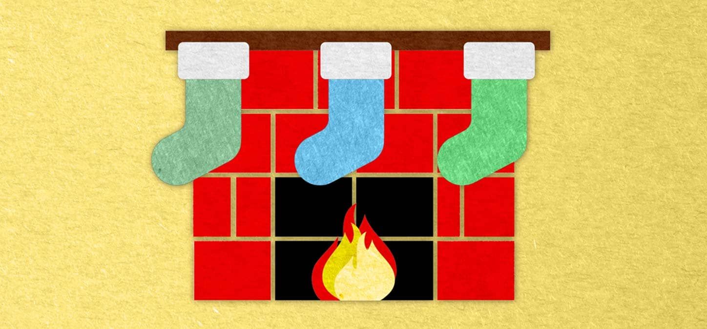Three christmas stockings are hanging on a fireplace.