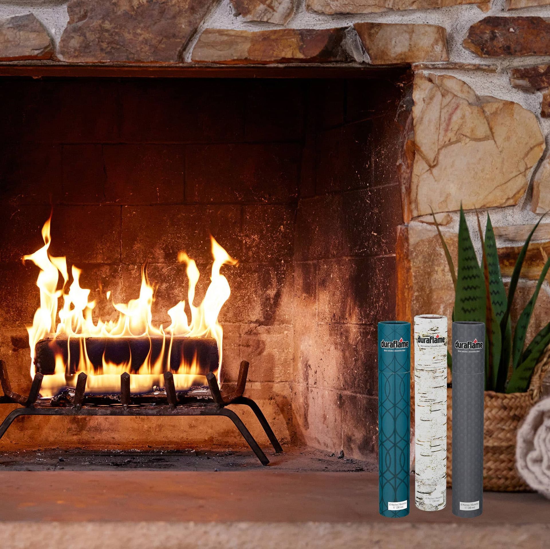 A duraflame fire burning in the fireplace with 3 tubes of duraflame decor long-stem matches for fire, decorative matches