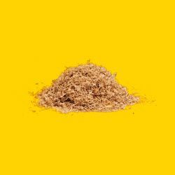 Recycled Sawdust A pile of wood sawdust on a yellow background.