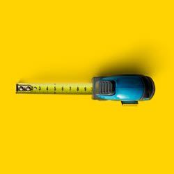 Number of Firelogs Produced A blue tape measure is on a yellow background.
