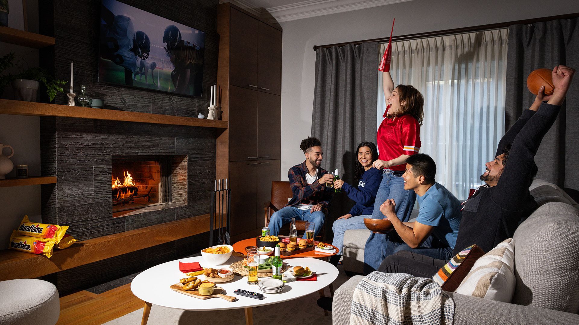 A group of people are celebrating in a living room.