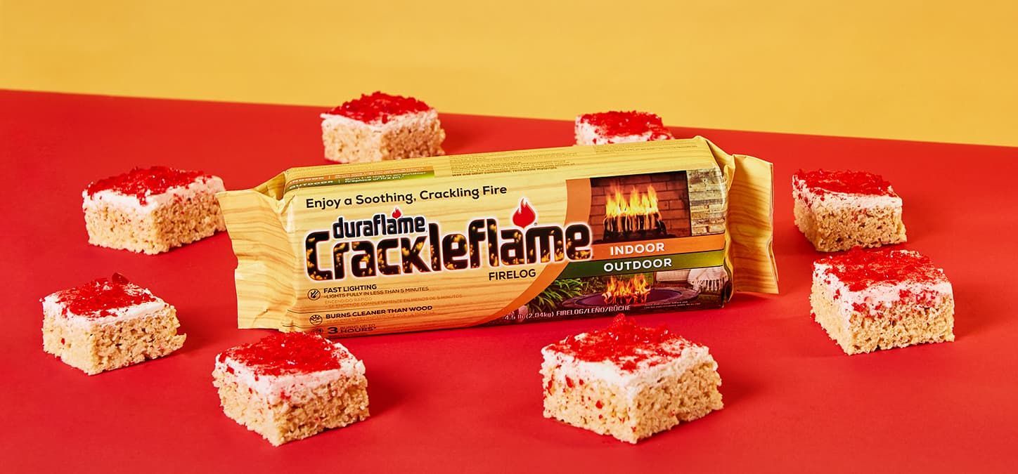 A package of crackle flame with hot cinnamon rice cereal treats on a red table.