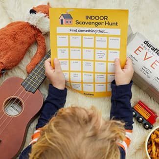 A child is holding a piece of paper that says